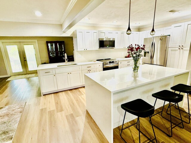 bedroom with access to exterior, light hardwood / wood-style floors, and ceiling fan