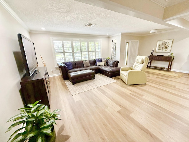 living room with ornamental molding, a textured ceiling, and light wood-type flooring