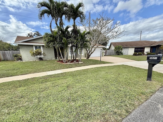 view of front of property featuring a garage and a front lawn