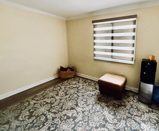 sitting room with crown molding and wood-type flooring