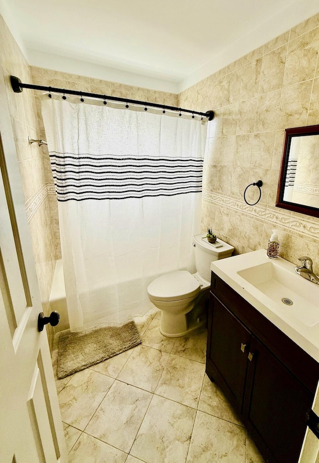 full bathroom featuring shower / bathtub combination with curtain, vanity, toilet, and tile walls