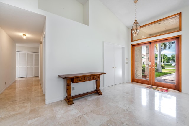 foyer with a high ceiling and french doors