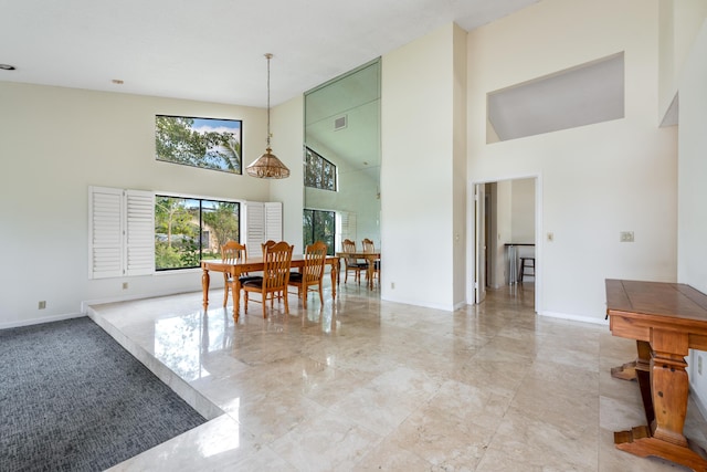 dining space with a high ceiling