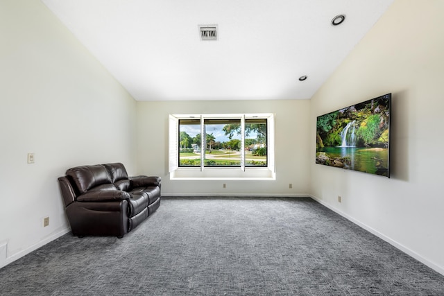 living area with carpet flooring and vaulted ceiling