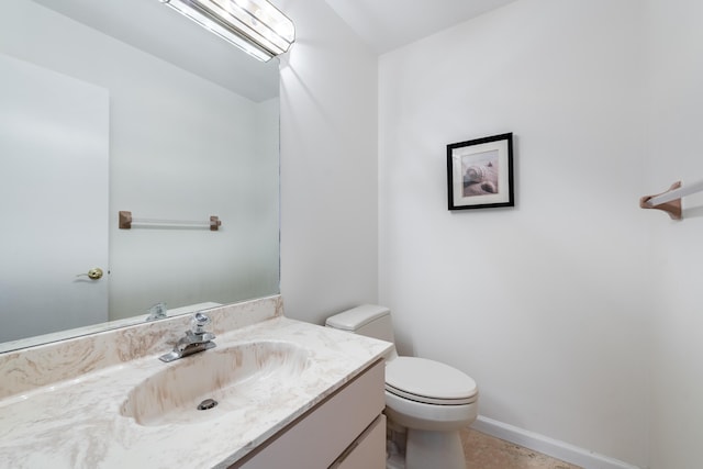 bathroom with tile patterned floors, vanity, and toilet