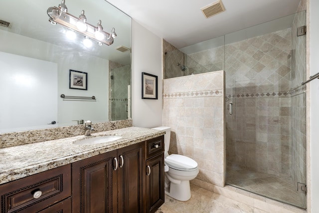 bathroom with vanity, an enclosed shower, and toilet