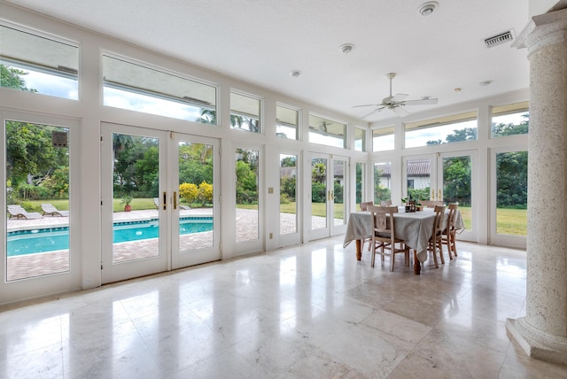 sunroom / solarium featuring ceiling fan and french doors