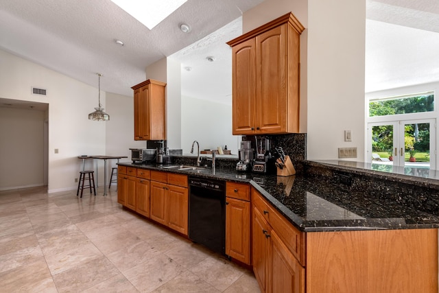 kitchen with dishwasher, dark stone countertops, a textured ceiling, decorative light fixtures, and lofted ceiling