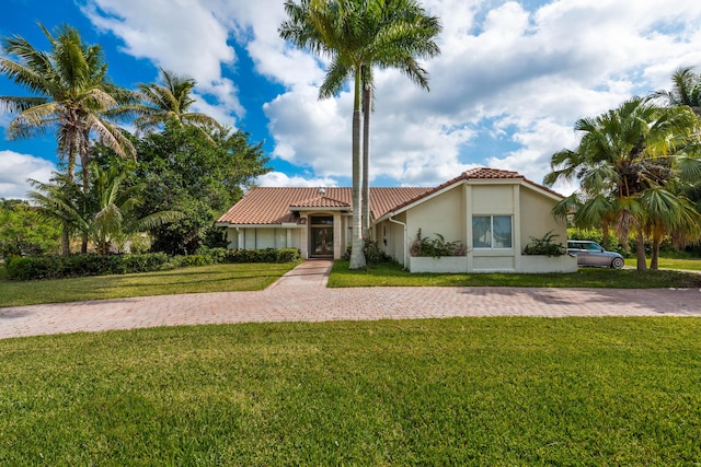 mediterranean / spanish-style house with a front yard