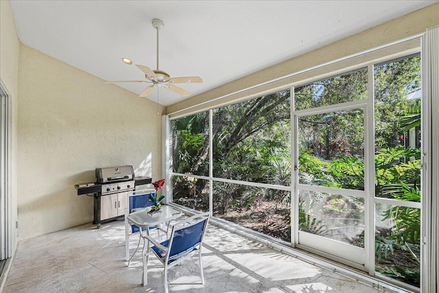 sunroom featuring ceiling fan