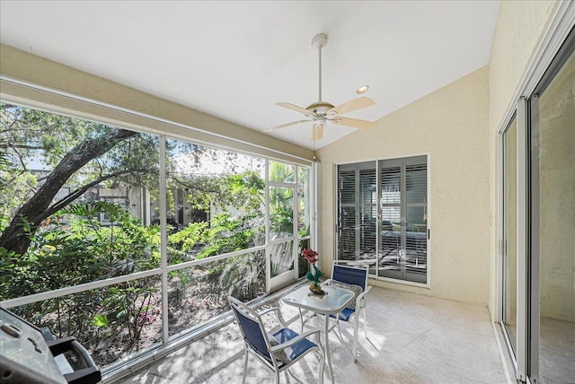 sunroom featuring ceiling fan and lofted ceiling