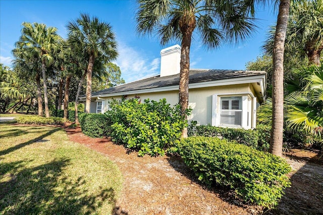 view of home's exterior with a lawn