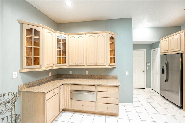 kitchen with stainless steel fridge with ice dispenser, light brown cabinets, and light tile patterned flooring