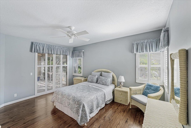 bedroom featuring multiple windows, dark hardwood / wood-style flooring, and ceiling fan