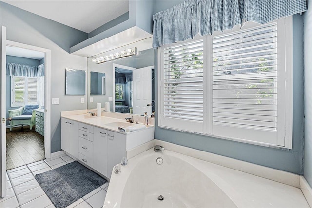 bathroom featuring vanity, tile patterned floors, and a bathing tub