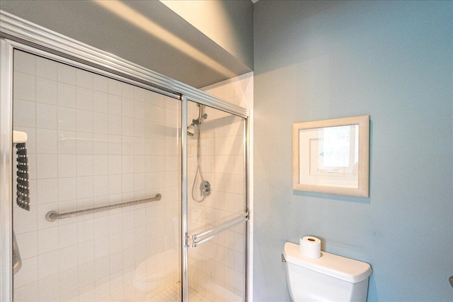 bathroom featuring toilet and walk in shower