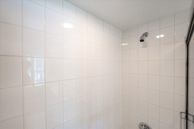 bathroom with a tile shower