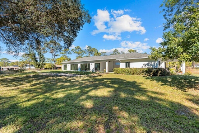 rear view of house with a lawn