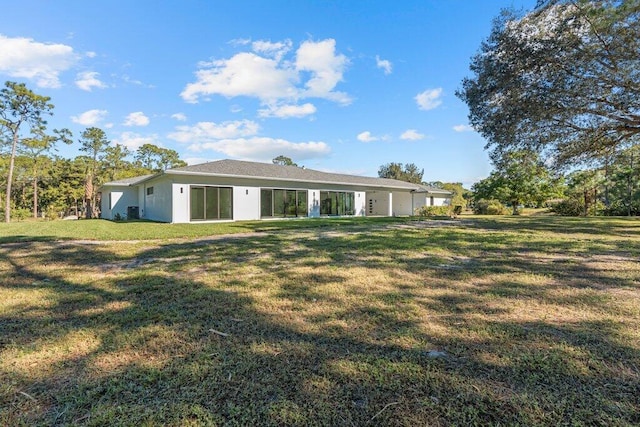 back of property featuring a yard