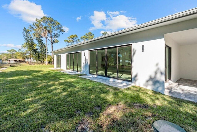 rear view of property featuring a yard