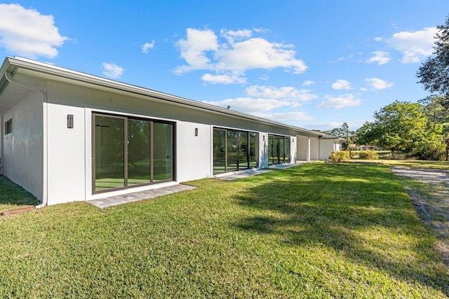 rear view of house with a yard