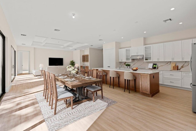 dining room featuring sink and light hardwood / wood-style floors