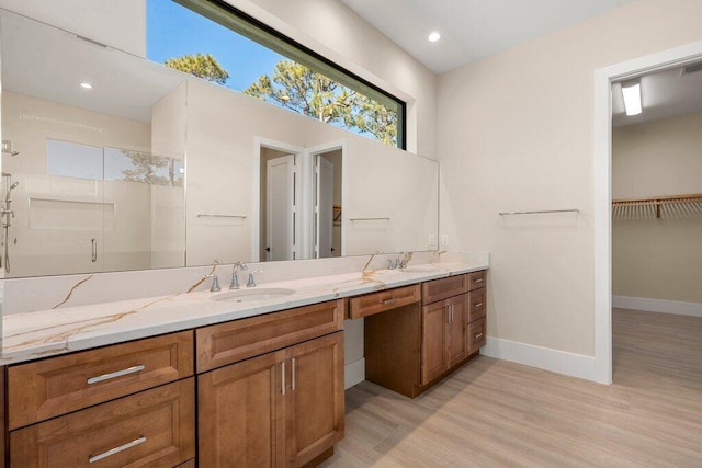 bathroom with vanity, hardwood / wood-style flooring, and an enclosed shower