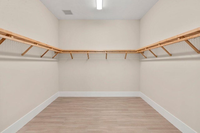 spacious closet featuring light hardwood / wood-style floors