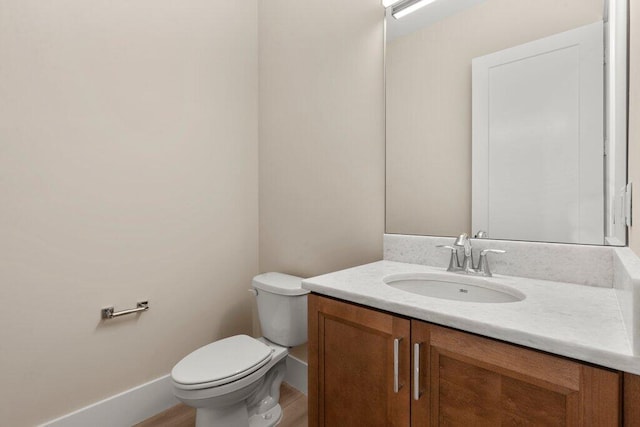 bathroom with toilet and vanity