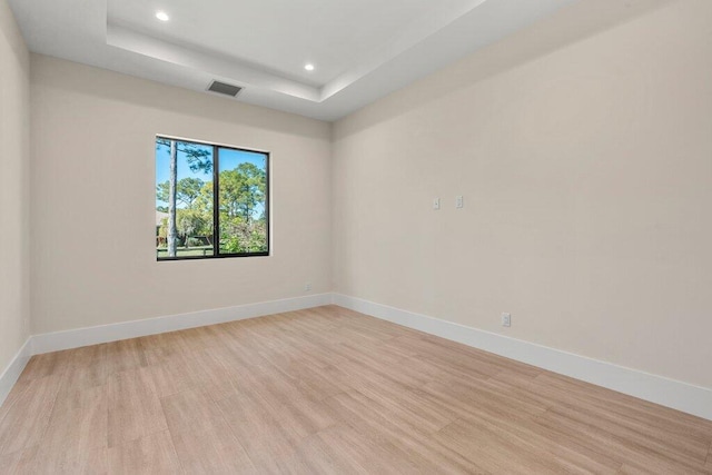 unfurnished room featuring a tray ceiling