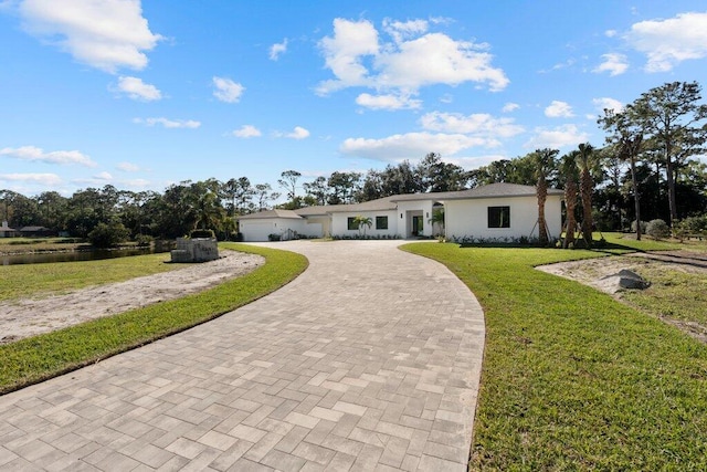 single story home with a front lawn and a garage