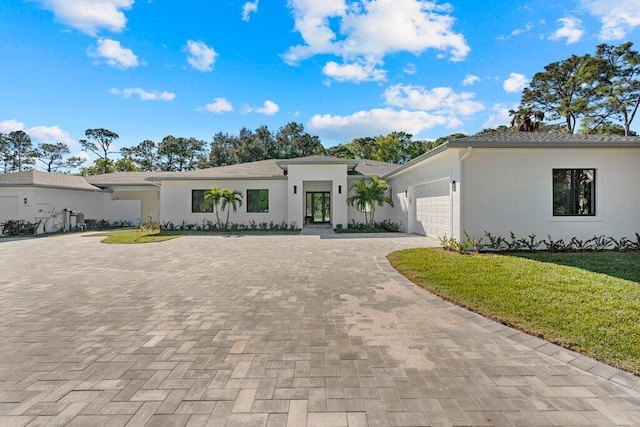 view of front of property with a front lawn and a garage