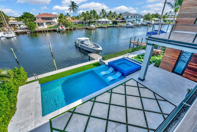 view of swimming pool with an in ground hot tub, a patio area, a dock, and a water view