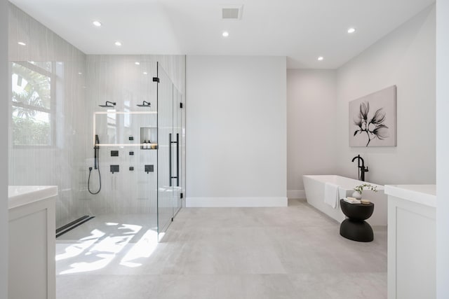 bathroom featuring vanity, a baseboard heating unit, and plus walk in shower