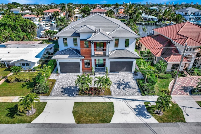 view of front facade with a garage and a water view