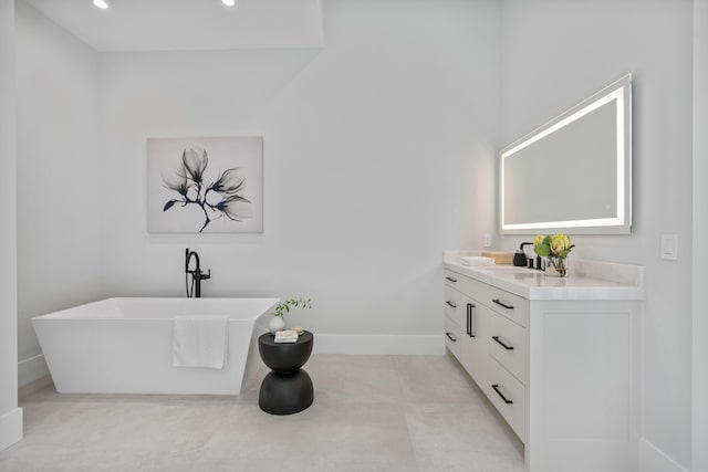 bathroom featuring a bath and vanity