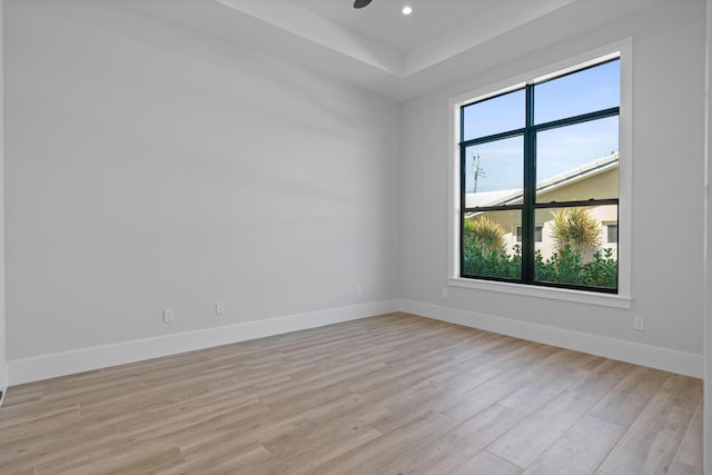 empty room with ceiling fan and light wood-type flooring