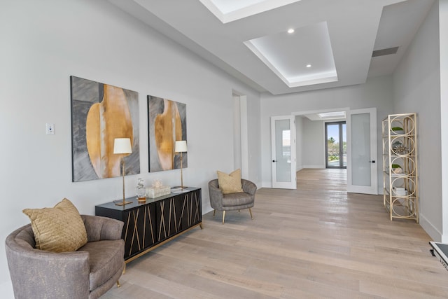 sitting room with light hardwood / wood-style flooring and french doors