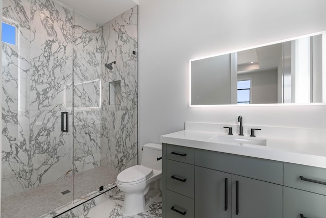 bathroom with toilet, vanity, and an enclosed shower