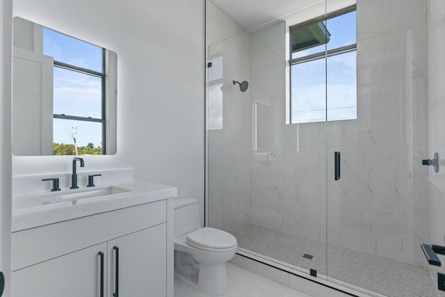 bathroom with toilet, tile patterned floors, a shower with door, and vanity