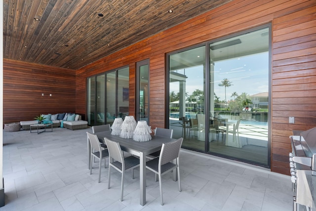 exterior space featuring outdoor lounge area and a water view