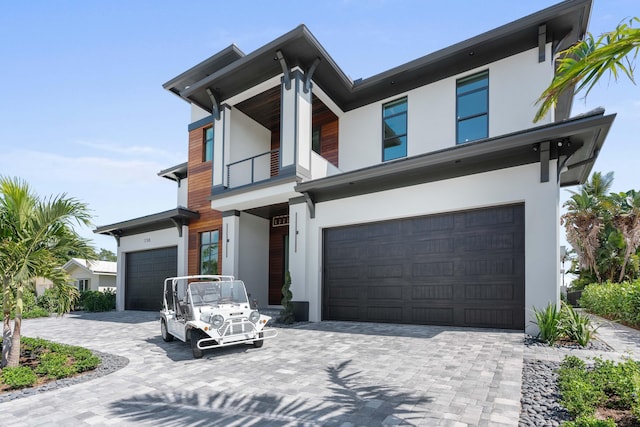 view of front facade featuring a garage and a balcony