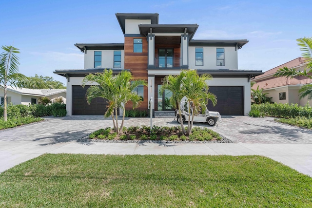 contemporary home featuring a front yard and a garage