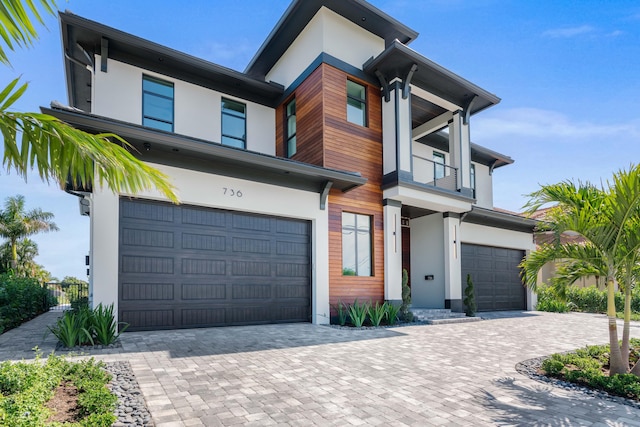 view of front facade featuring a balcony and a garage