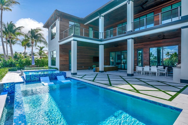 view of pool with ceiling fan, a patio area, and an in ground hot tub