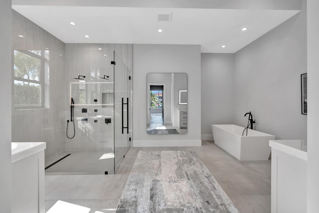 bathroom with plus walk in shower, concrete flooring, and vanity