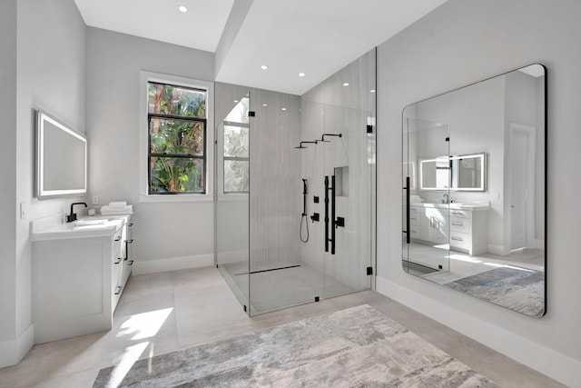 bathroom with vanity and a shower with door