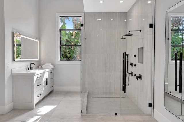 bathroom with an enclosed shower and vanity