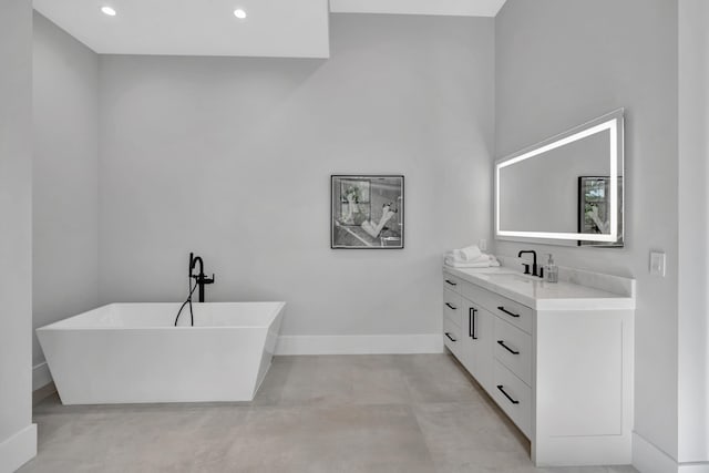 bathroom with vanity and a washtub