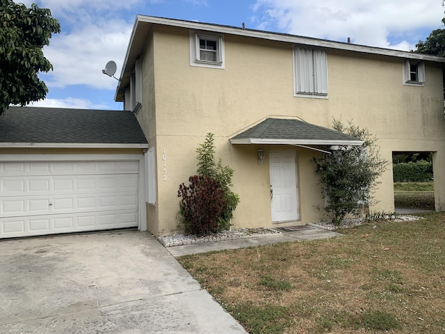 front of property featuring a garage and a front lawn